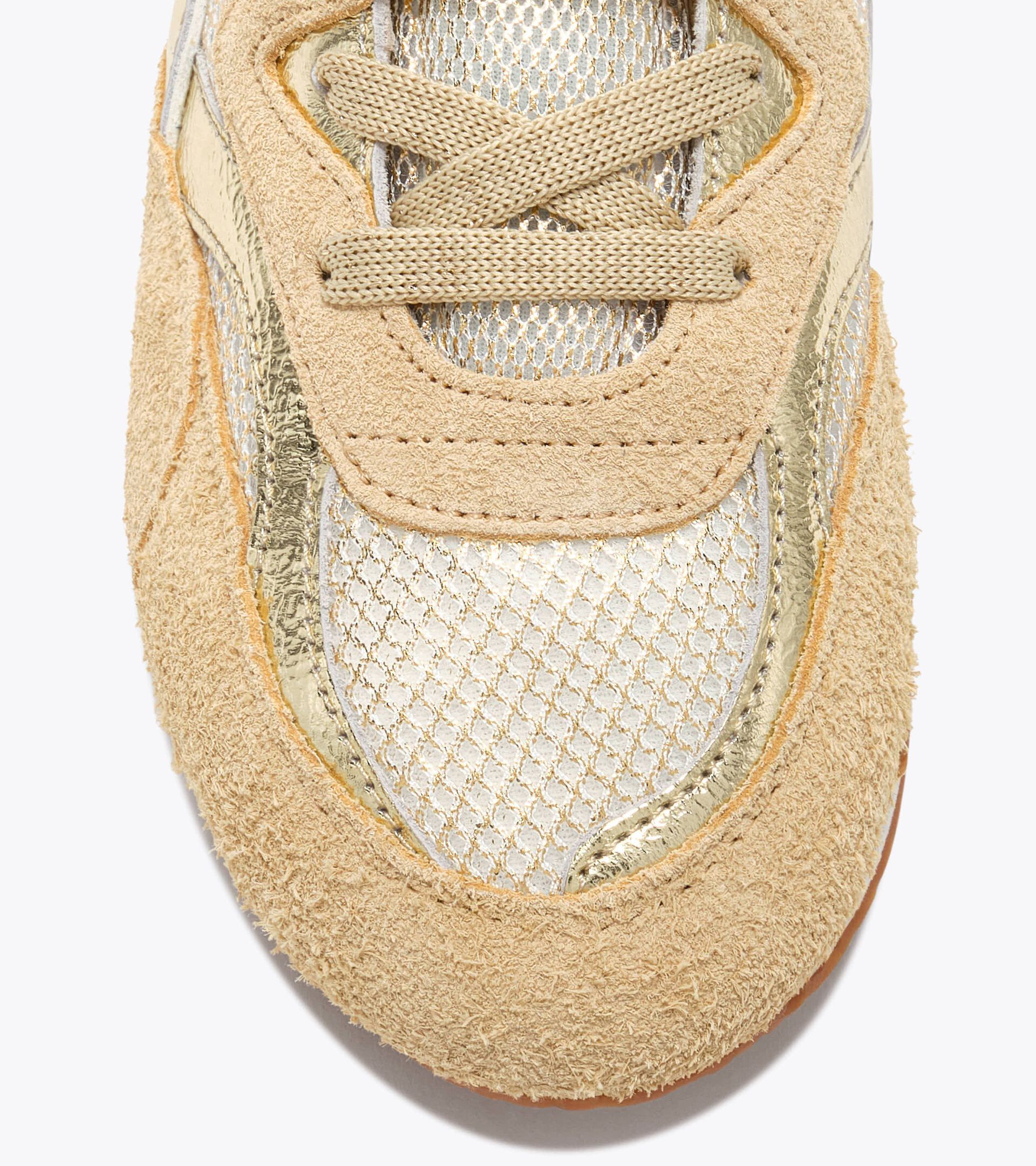 Zapatilla Heritage de ante - Para todos los g&eacute;neros
 EQUIPE REVENGE IRIDE WN ORO RICO - Diadora