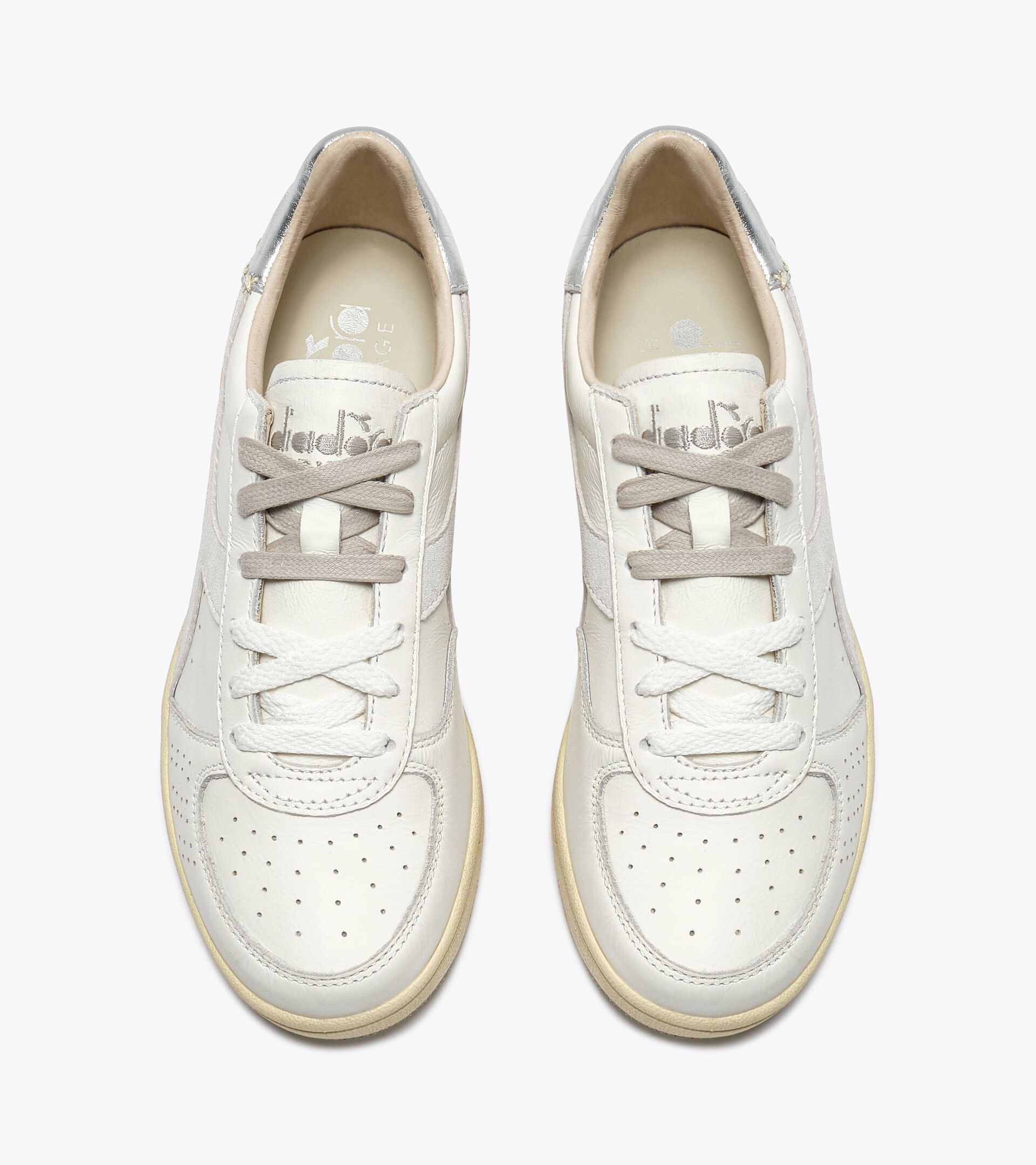 Zapatilla Heritage de piel - Para todos los g&eacute;neros
 B.ELITE X-STITCH WN BLANCO/PLATA  (C6103) - Diadora